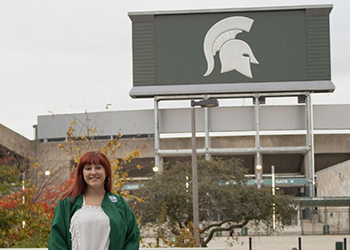 A student in front of Spartan stadium